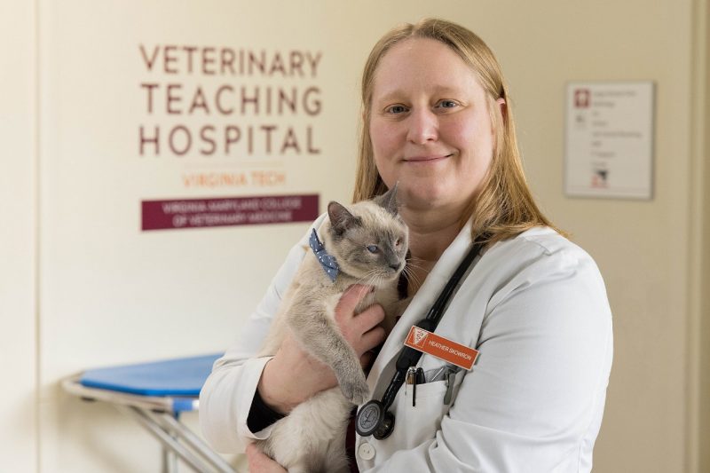 Portrait of Heather Skowron holding a cat.